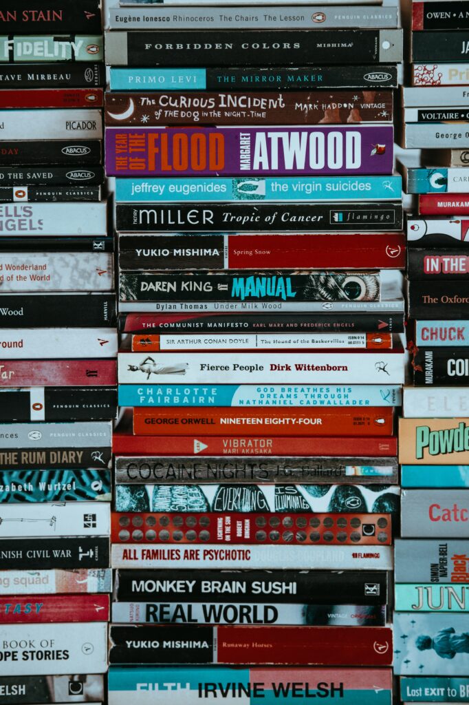 A tall stack of paperback books.